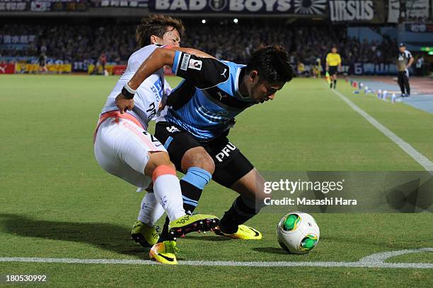 Yusuke Tanaka of Kawasaki Frontale and Kohei Shimizu of Sanfrecce Hiroshima compete for the ball during the J.League match between Kawasaki Frontale...