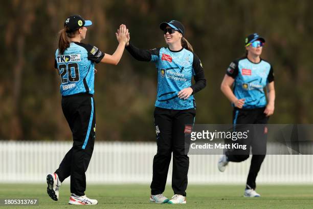 Amanda-Jade Wellington of the Strikers celebrates with team mates after taking a catch to dismiss Olivia Porter of the Thunder during the WBBL match...