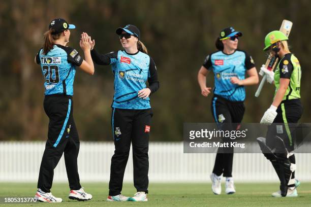 Amanda-Jade Wellington of the Strikers celebrates with team mates after taking a catch to dismiss Olivia Porter of the Thunder during the WBBL match...