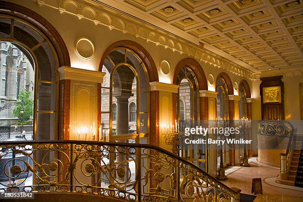 grillwork and chandeliers in hotel lobby - lobby foto e immagini stock