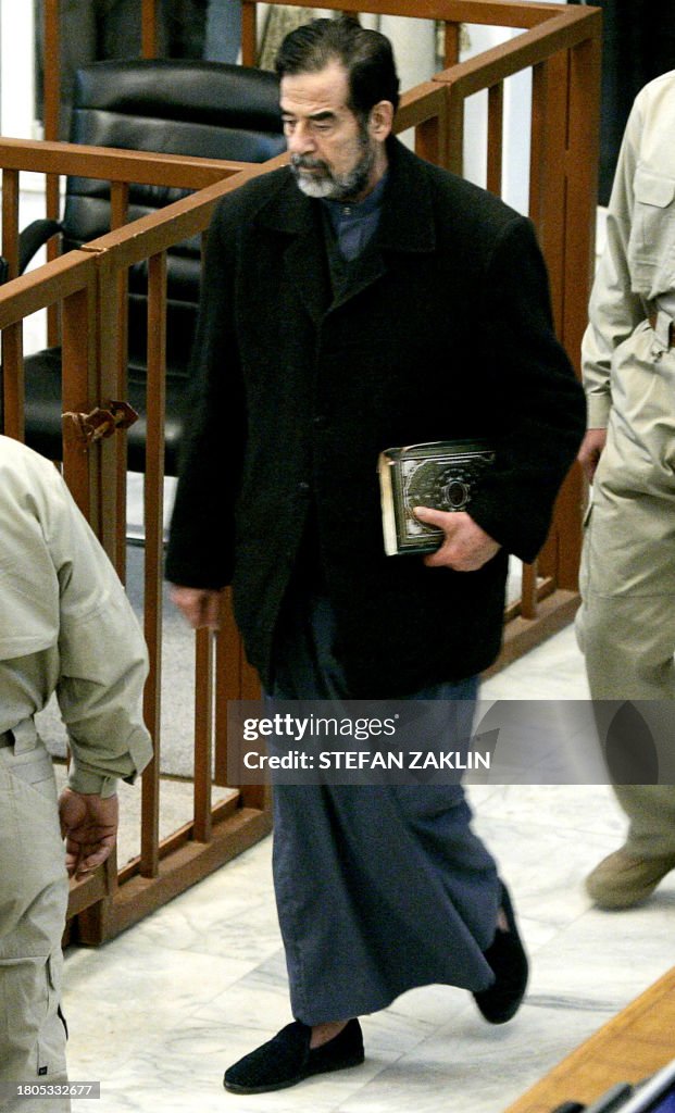 Sadam R 2 TOPSHOT - Former Iraqi President Saddam Hussein walks into court ...