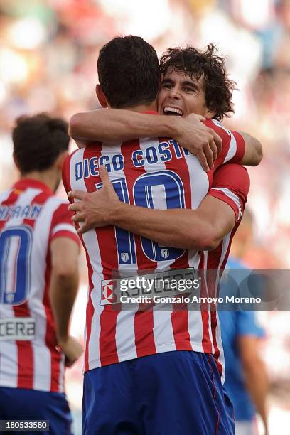 Tiago Mendes of Atletico de Madrid embraces his teammate Diego Costa after scoring their third goal during the La Liga match between Club Atletico de...
