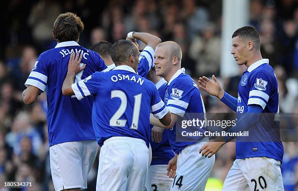 Steven Naismith of Everton celebrates wit his team-mates after scoring the opening goal during the Barclays Premier League match between Everton and...