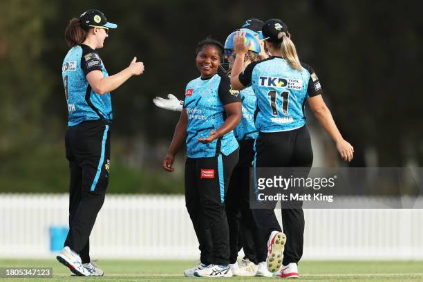Anesu Mushangwe of the Strikers celebrates victory with team mates after bowling the final over during the WBBL match between Sydney Thunder and...