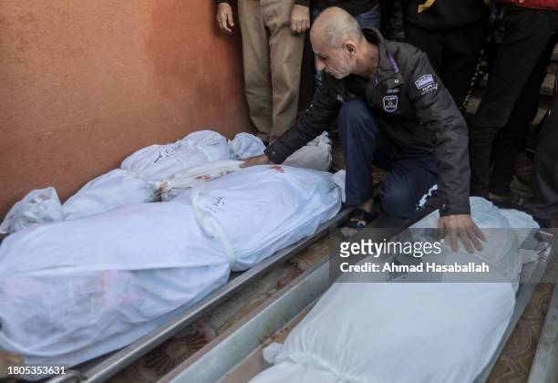 People mourn as they collect the bodies of Palestinians killed in an airstrike on November 21, 2023 in Khan Yunis, Gaza. More Gaza residents have...