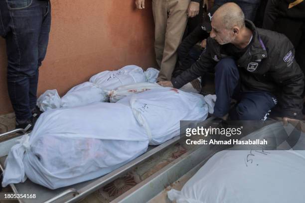People mourn as they collect the bodies of Palestinians killed in an airstrike on November 21, 2023 in Khan Yunis, Gaza. More Gaza residents have...