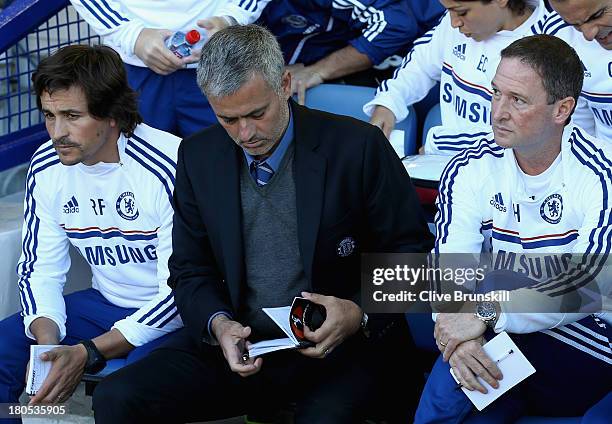 Chelsea Manager Jose Mourinho looks on with Assistants Rui Faria and Steve Holland prior to the Barclays Premier League match between Everton and...