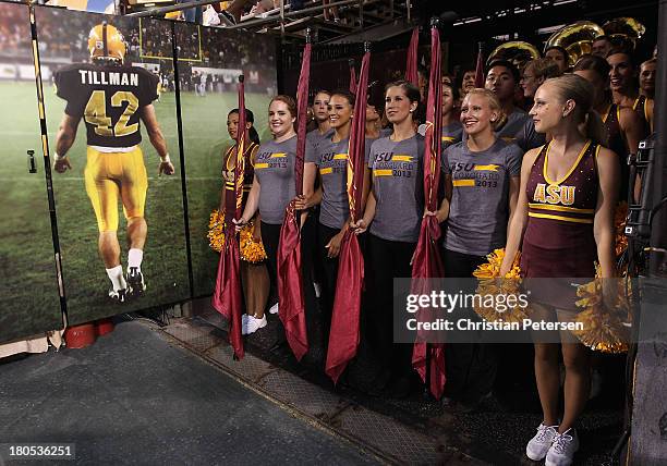 The Arizona State Sun Devils cheer team prepare to walk past a Pat Tillman photograph before the college football game against the Sacramento State...