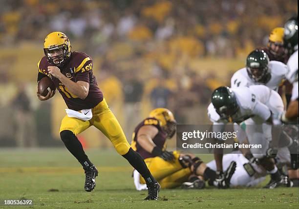 Quarterback Taylor Kelly of the Arizona State Sun Devils scrambles with the football during the college football game against the Sacramento State...