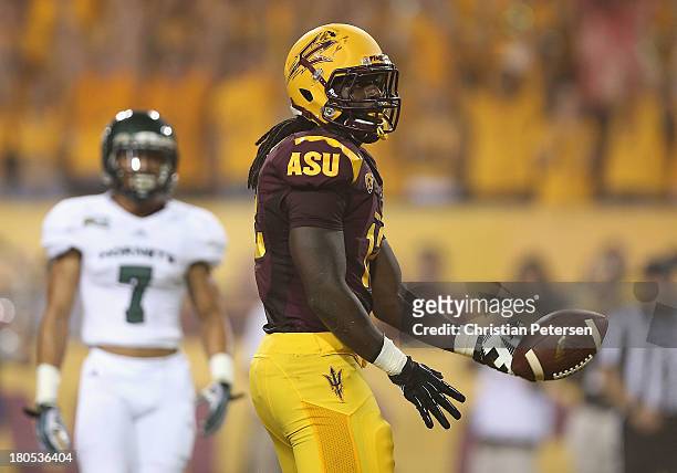 Tight end De'Marieya Nelson of the Arizona State Sun Devils flips the football after scoring a 15 touchdown reception against the Sacramento State...