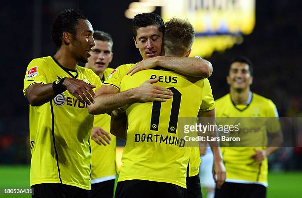 Robert Lewandowski of Dortmund celebrates with team mate Pierre Aubameyang after scoring his teams fifth goal during the Bundesliga match between...