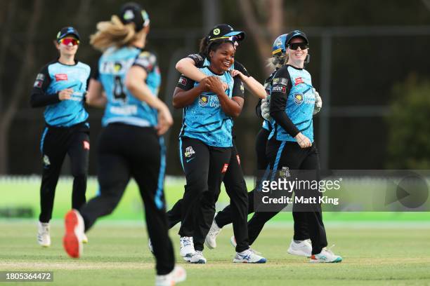 Anesu Mushangwe of the Strikers celebrates with team mates after taking the wicket of Tahlia Wilson of the Thunder during the WBBL match between...