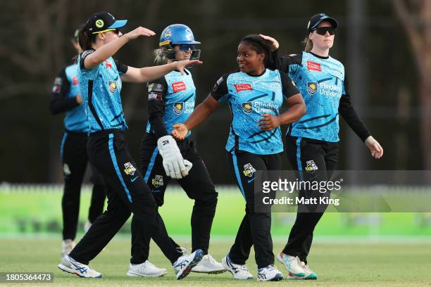 Anesu Mushangwe of the Strikers celebrates with team mates after taking the wicket of Tahlia Wilson of the Thunder during the WBBL match between...