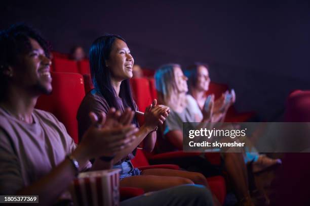 applauding after a movie at cinema! - film festival stock pictures, royalty-free photos & images