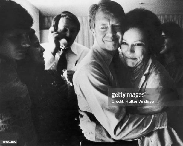 Democratic presidential candidate Jimmy Carter embraces his wife Rosalynn after receiving the final news of his victory in the national general...
