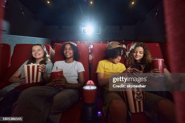 happy little friends enjoying in movie projection at theatre. - good boy premiere stock pictures, royalty-free photos & images