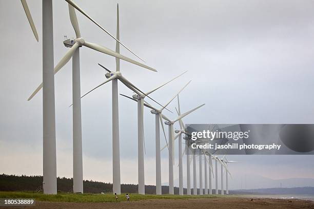 wind turbines lined up in a row - wind power japan stock pictures, royalty-free photos & images