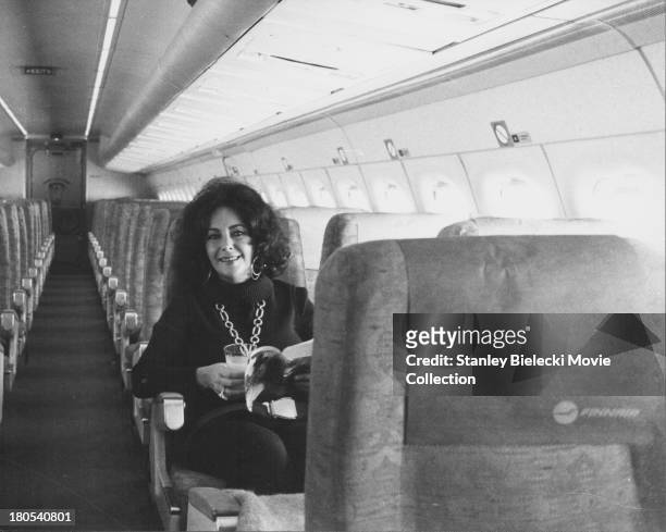Candid shot of actress Elizabeth Taylor on her personal airplane, circa 1970-1980.