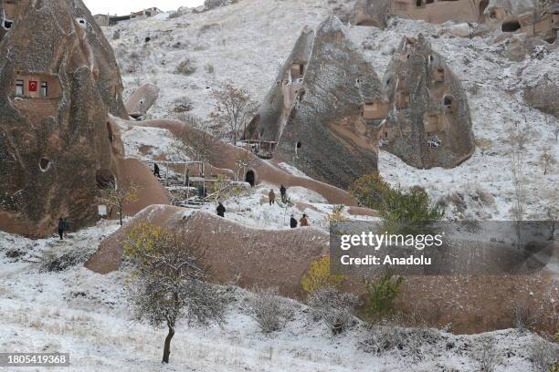 Local and foreign tourists visit the snow covered fairy chimneys after snowfall in Cappadocia, which is preserved as a UNESCO World Heritage site and...