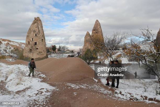 Local and foreign tourists visit the snow covered fairy chimneys after snowfall in Cappadocia, which is preserved as a UNESCO World Heritage site and...