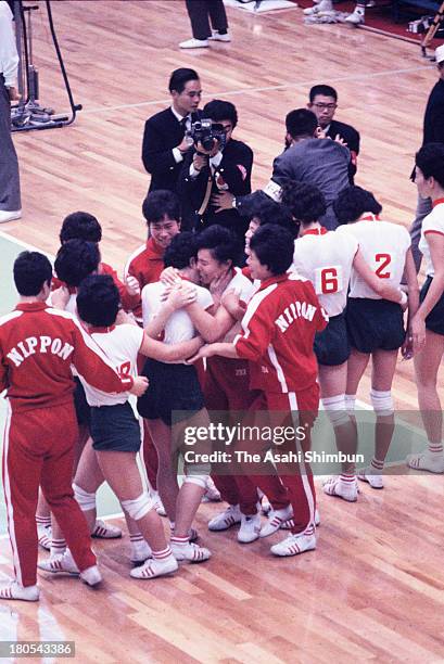 Japanese players celebrate winning the gold after the Women's Volleyball Gold Medal match between Japan and Soviet Union during the Tokyo Olympics at...
