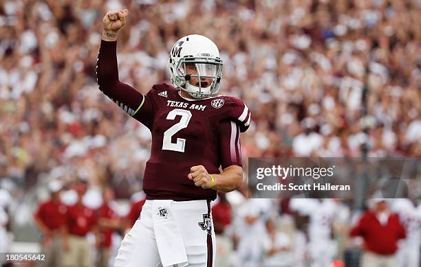 Johnny Manziel of the Texas A&M Aggies celebrates after throwing a first quarter touchdown during a game against the Alabama Crimson Tide at Kyle...