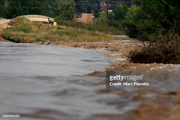 Deer is trapped on a temporary island by rising flood waters from the South Platte River September 14, 2013 near Wiggins, Colorado. Heavy rains for...