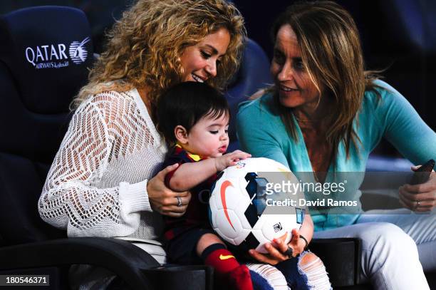 Shakira and Montserrat Bernabeu, Gerard Pique's mother, play with Milan prior to the La Liga match between FC Barcelona and Sevilla FC at Camp Nou on...