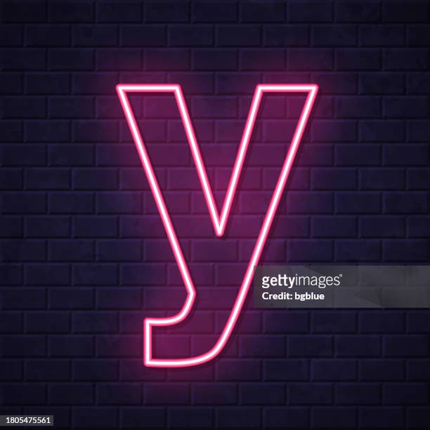 letter y. glowing neon icon on brick wall background - letter y stock illustrations