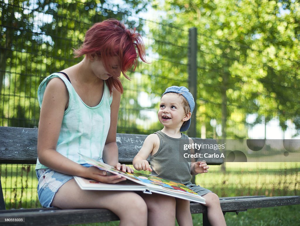 Baby boy and mom reading