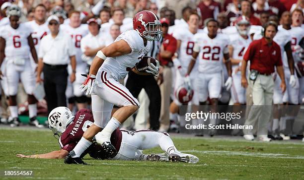 Johnny Manziel of Texas A&M Aggies cannot tackle Vinnie Sunseri of the Alabama Crimson Tide as he runs for a 73 yard touchdown after an interception...