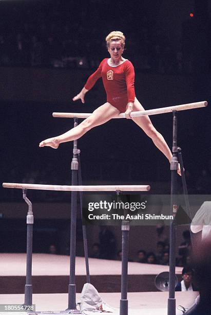 Vera Caslavska of Czechoslovakia competes in the Uneven Bars of the Women's Artistic Gymnastics Individual All-Around during the Tokyo Olympics at...