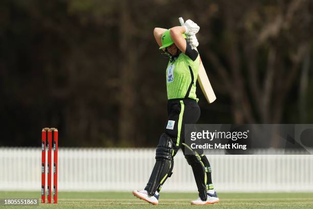 Anika Learoyd of the Thunder looks dejected as she walks from the field after being dismissed during the WBBL match between Sydney Thunder and...