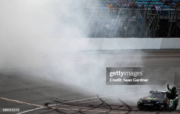Kyle Busch, driver of the Monster Energy Toyota, celebrates with a burnout after winning the NASCAR Nationwide Series Dollar General 300 Powered by...
