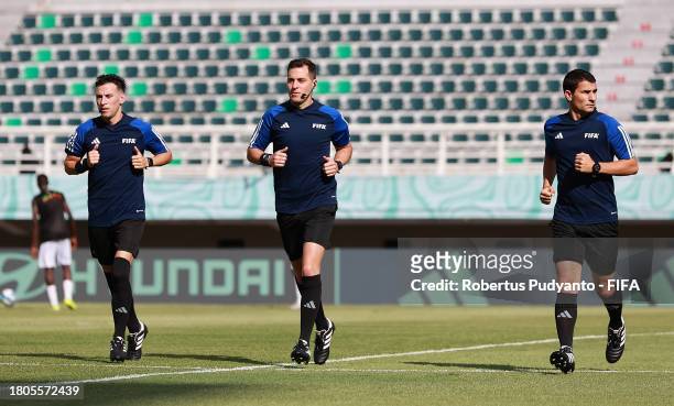 Referee Gustavo Tejera warms up with Assistant Referees Carlos Barreiro and Andres Nievas prior to the FIFA U-17 World Cup Round of 16 match between...
