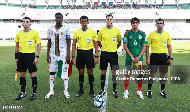 Ibrahim Diarra of Mali poses for a photograph with match officials Referee Gustavo Tejera and Assistant Referees Carlos Barreiro, Ivo Nigel Mendez...