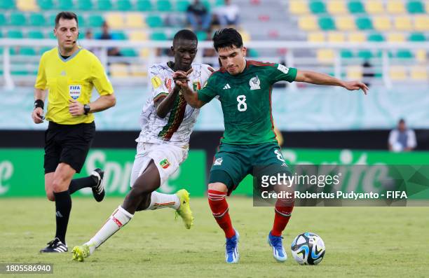 Jose Urias of Mexico battles for possession with Ousmane Thiero of Mali during the FIFA U-17 World Cup Round of 16 match between Mali and Mexico at...