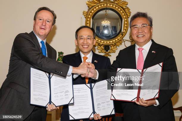 British Foreign Secretary David Cameron, South Korea's Deputy Prime Minister Choo Kyung-ho and South Korean Foreign Minister Park Jin pose for...