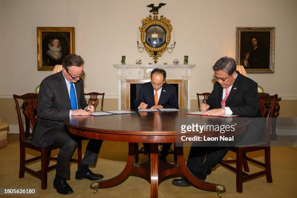 British Foreign Secretary David Cameron, South Korea's Deputy Prime Minister Choo Kyung-ho and South Korean Foreign Minister Park Jin sign a joint...