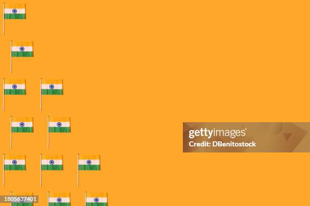 pattern of flags of the republic of india, on the left side, on orange background. independence day concept, 15 august, republic day of india, celebration, orange, green, white and patriotism. - january icon stock pictures, royalty-free photos & images