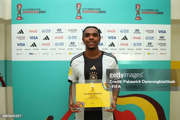Charles Herrmann of Germany poses for a photo with the Player Of The Match award after their sides victory in the FIFA U-17 World Cup Round of 16...