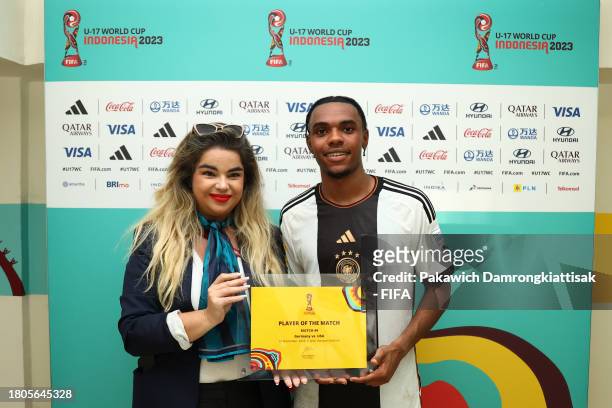 Charles Herrmann of Germany poses for a photo with the Player Of The Match award after their sides victory in the FIFA U-17 World Cup Round of 16...