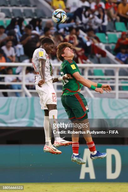 Gaoussou Kone of Mali and Tahiel Jimenez of Mexico compete for a header during the FIFA U-17 World Cup Round of 16 match between Mali and Mexico at...