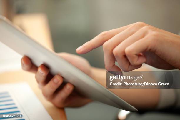 close-up of unrecognizable person hands using digital tablet - touchpad stock-fotos und bilder