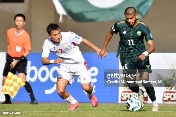 Harun Ar-Rashid Faheem from Pakistan tackles the ball from Parvizdzhon Umarbaev from Tajikistan during the 2026 FIFA World Cup AFC Qualifier Group G...