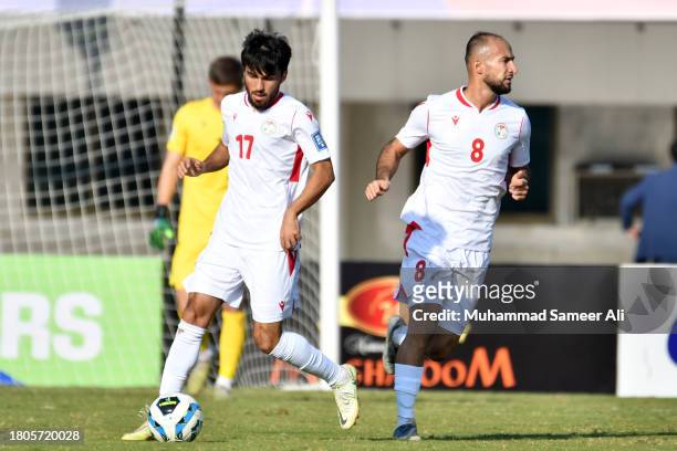 Ehson Panjshanbe from Tajikistan takes the ball with Amirbek Juraboev during the 2026 FIFA World Cup AFC Qualifier Group G match between Pakistan and...