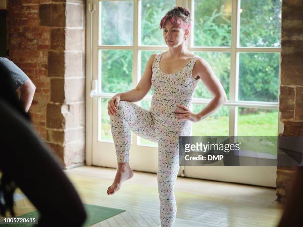 yoga, woman stretching legs in class and exercise, fitness and healthy body, wellness or pilates. knee to chest pose, person in gym and balance, practice and flexibility with calm or girl in studio - leg stretch girl stock pictures, royalty-free photos & images