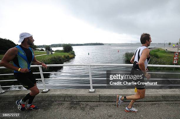 Participants compete in the run part of the race during the Challenge Triathlon Almere-Amsterdam on September 14, 2013 in Almere, Netherlands.