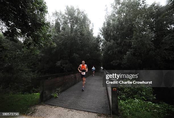 Participants compete in the run part of the race during the Challenge Triathlon Almere-Amsterdam on September 14, 2013 in Almere, Netherlands.