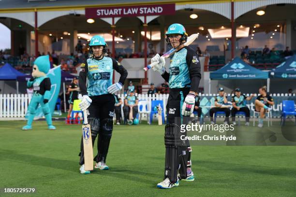 Grace Harris and Georgia Redmayne of the Heat walk out during the WBBL match between Brisbane Heat and Sydney Sixers at Allan Border Field, on...